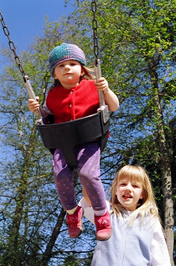 Rebecca pushing Jessica on swing